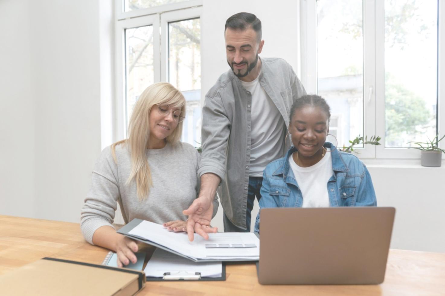 Financial professionals collaborating on scenario modeling projects in modern learning environment